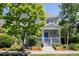Beautiful two-story home featuring a welcoming front porch, complemented by lush landscaping and mature trees at 10069 E 28Th Ave, Denver, CO 80238
