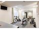 Finished basement gym with mirrored wall and workout equipment at 10069 E 28Th Ave, Denver, CO 80238