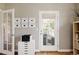 Bright office space with built in shelving, modern furnishings, and a french door to porch at 10069 E 28Th Ave, Denver, CO 80238