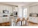 Bright kitchen featuring stainless appliances, a center island with seating, and white cabinets at 10069 E 28Th Ave, Denver, CO 80238