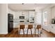 Bright kitchen featuring stainless appliances, a center island with seating, and white cabinets at 10069 E 28Th Ave, Denver, CO 80238