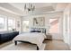 Airy main bedroom with tray ceiling, large windows, a dresser, and nightstands at 10069 E 28Th Ave, Denver, CO 80238