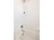 Simple white tiled shower featuring a new shower head at 10069 E 28Th Ave, Denver, CO 80238