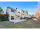 Rear exterior of the home with a spacious yard and wooden deck at 19697 E Flora Pl, Aurora, CO 80013