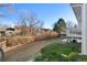 Wide backyard featuring a lawn, mature trees, and a deck with white railings at 19697 E Flora Pl, Aurora, CO 80013