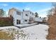 Back exterior with a patio, lawn, and some greenery and a white exterior wall at 19697 E Flora Pl, Aurora, CO 80013