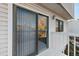 Balcony featuring a sliding glass door, white railings, and an exterior light fixture at 19697 E Flora Pl, Aurora, CO 80013