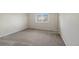 Neutral bedroom featuring plush carpet floors and a large window at 19697 E Flora Pl, Aurora, CO 80013