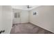 Cozy carpeted bedroom with a ceiling fan, two windows, and neutral walls creating a serene retreat at 19697 E Flora Pl, Aurora, CO 80013