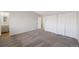 Spacious bedroom with neutral walls, carpet, and closet with sliding doors for optimal storage solutions at 19697 E Flora Pl, Aurora, CO 80013