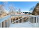 View of a deck overlooking the backyard with mature trees and neighboring houses at 19697 E Flora Pl, Aurora, CO 80013
