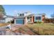 Charming two-story home featuring a blue garage door, brick accents, and a well-maintained front yard at 19697 E Flora Pl, Aurora, CO 80013