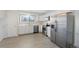 Bright kitchen with white cabinets, stainless steel appliances, and wood grain flooring at 19697 E Flora Pl, Aurora, CO 80013
