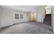 Bright, spacious living room with plush gray carpeting, neutral walls, and abundant natural light at 19697 E Flora Pl, Aurora, CO 80013