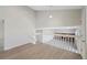 Open living area with vaulted ceilings, wood floors, and a view of the lower-level fireplace at 19697 E Flora Pl, Aurora, CO 80013