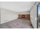 Spacious living room with a red brick fireplace and access to the outdoor deck at 19697 E Flora Pl, Aurora, CO 80013