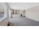 Open living area with carpet flooring, access to the staircase and sliding glass door at 19697 E Flora Pl, Aurora, CO 80013