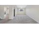 Open living space featuring plush carpeting and soft lighting, ideal for relaxing and entertaining guests at 19697 E Flora Pl, Aurora, CO 80013