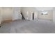 Spacious living room with light-colored walls, plush gray carpeting, and an open layout perfect for entertaining at 19697 E Flora Pl, Aurora, CO 80013