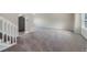 Expansive living room with stairs, an open floor plan, and neutral finishes providing a blank canvas for customization at 19697 E Flora Pl, Aurora, CO 80013
