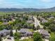 An aerial view of neighborhood homes with mountain views and lush green trees at 2555 S Zang St, Denver, CO 80228