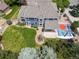 Aerial view of the spacious backyard, showcasing the patio, sports court, and lush landscaping at 2555 S Zang St, Denver, CO 80228