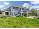 Expansive backyard showcases lush lawn, manicured landscaping, and a stylish patio, ideal for outdoor enjoyment at 2555 S Zang St, Denver, CO 80228