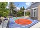 Home features a colorful, full basketball court and covered patio perfect for outdoor fun and entertaining at 2555 S Zang St, Denver, CO 80228
