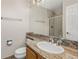 Bathroom with granite countertops, a vanity, a large mirror, and a shower behind glass door at 2555 S Zang St, Denver, CO 80228