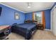 Cozy bedroom featuring blue walls, carpet floors, and a ceiling fan at 2555 S Zang St, Denver, CO 80228