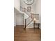 Inviting foyer with hardwood floors, elegant staircase with iron spindles, and a decorative table at 2555 S Zang St, Denver, CO 80228