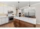 Elegant kitchen with a center island, stainless steel appliances, white cabinets, and hardwood flooring at 2555 S Zang St, Denver, CO 80228