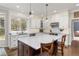 Modern kitchen with a large island, white cabinets, and stainless steel appliances at 2555 S Zang St, Denver, CO 80228
