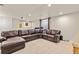 Basement living room with a large leather sofa and neutral walls and carpet at 2555 S Zang St, Denver, CO 80228