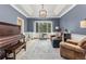 Comfortable living room with an area rug, a piano, cozy seating, and natural light at 2555 S Zang St, Denver, CO 80228