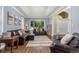 Stylish living room with hardwood floors, neutral walls, leather sofas, and a large window at 2555 S Zang St, Denver, CO 80228