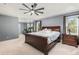 Large main bedroom with tray ceiling, carpet, windows, and ample space for exercise equipment at 2555 S Zang St, Denver, CO 80228