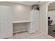 Bright office space featuring white cabinets, a built-in desk, and soft carpet at 2555 S Zang St, Denver, CO 80228