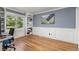 Bright office space with hardwood floors, built-in shelves, wainscoting, and large window with backyard view at 2555 S Zang St, Denver, CO 80228