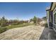 Spacious backyard with a stamped concrete patio and a well-maintained lawn at 21701 E 50Th Dr, Aurora, CO 80019