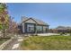 Back of house with a landscaped yard and patio at 21701 E 50Th Dr, Aurora, CO 80019