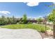 Serene backyard featuring a well-manicured lawn, mature trees, and a stamped concrete patio at 21701 E 50Th Dr, Aurora, CO 80019