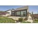 A well-maintained backyard with a concrete patio and lush landscaping at 21701 E 50Th Dr, Aurora, CO 80019
