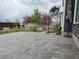 Beautiful backyard patio with patterned concrete and flowering trees creating a peaceful outdoor space at 21701 E 50Th Dr, Aurora, CO 80019