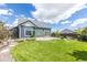 Inviting backyard with a lush lawn, patio, and well-maintained landscaping at 21701 E 50Th Dr, Aurora, CO 80019
