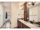 Double sink vanity with stainless faucets adjacent to bedroom at 21701 E 50Th Dr, Aurora, CO 80019