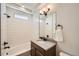 Clean, well-lit bathroom featuring a bathtub and shower combination with tiled walls at 21701 E 50Th Dr, Aurora, CO 80019