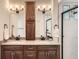 Bright bathroom featuring double sinks with quartz countertops, and a large shower with marbled tile at 21701 E 50Th Dr, Aurora, CO 80019