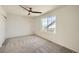 Bedroom with neutral carpet, a ceiling fan, and a window with a view of the neighborhood at 21701 E 50Th Dr, Aurora, CO 80019