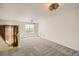 Bonus room featuring neutral walls, plush carpet, and a window with natural light at 21701 E 50Th Dr, Aurora, CO 80019